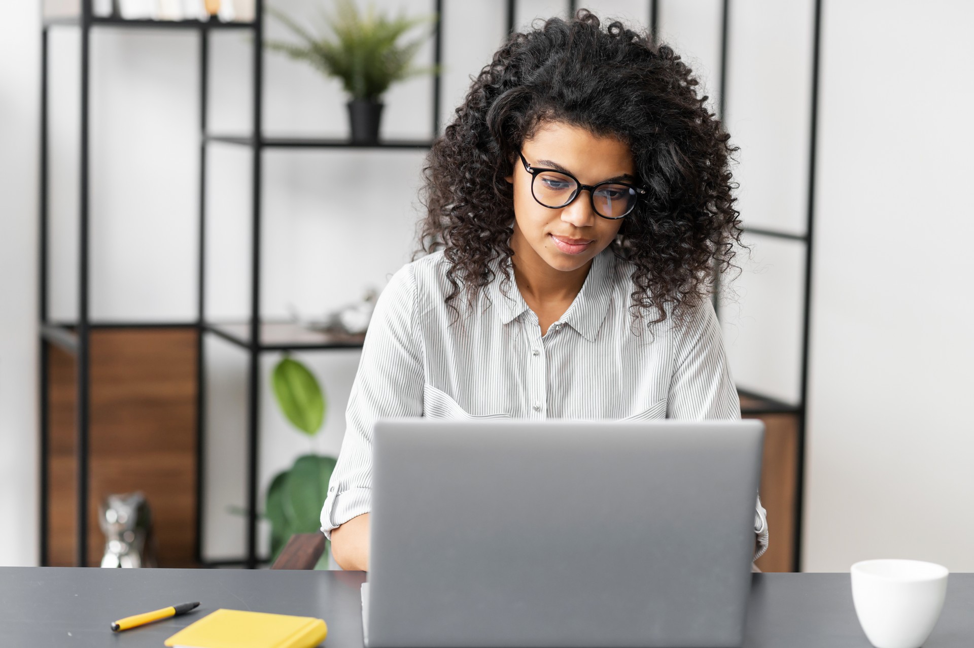 African American female student working on laptop