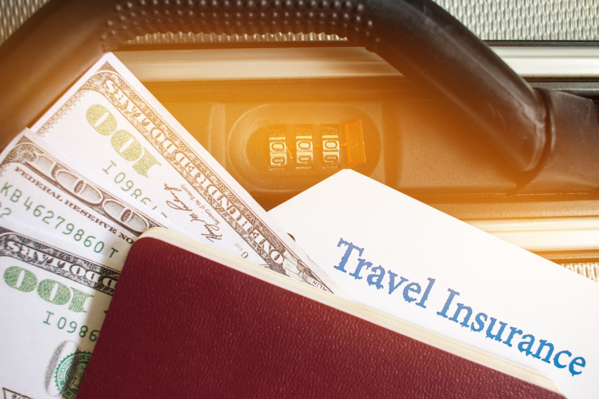 Travel Insurance tag on suitcase near numeric combination lock,passport and US Dollar. Travel Insurance is intended cover medical expenses,cover lost luggage flight cancellation or accident